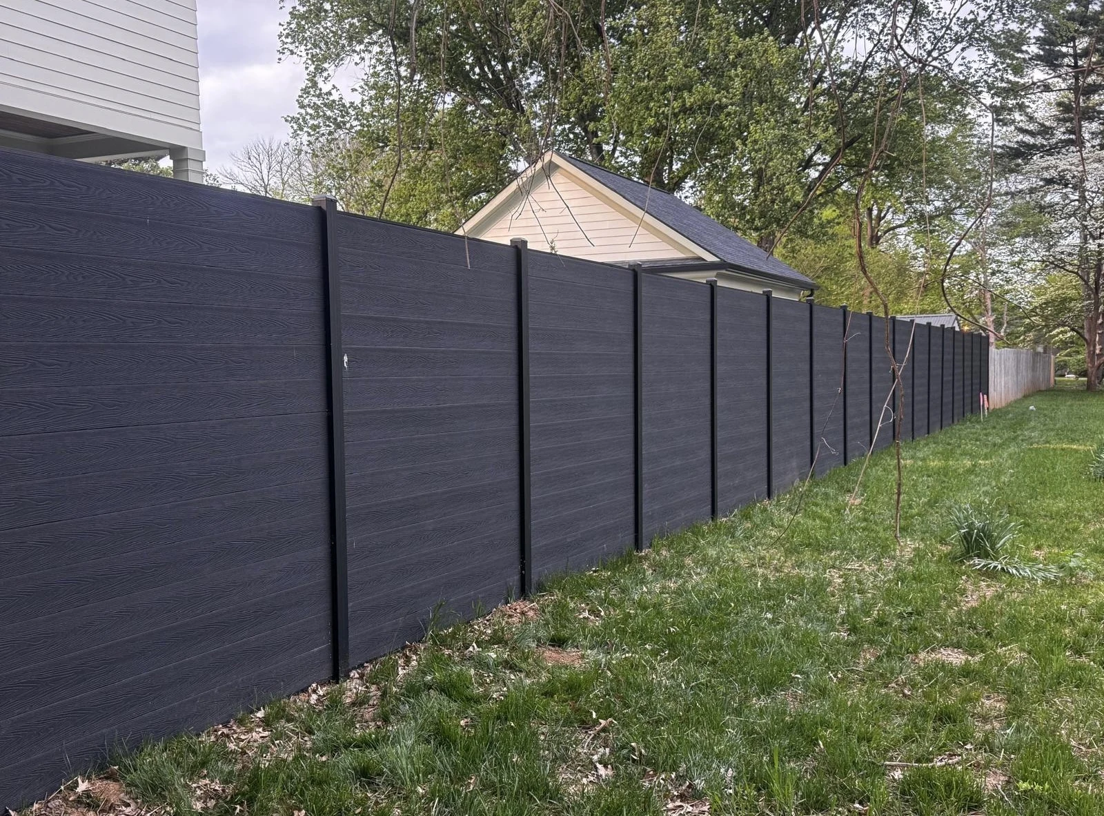 Dark horizontal fence panels alongside a home