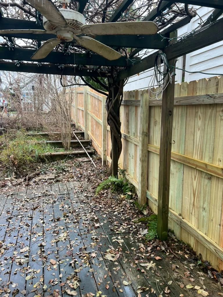 Wood fence and outdoor structure beside a home